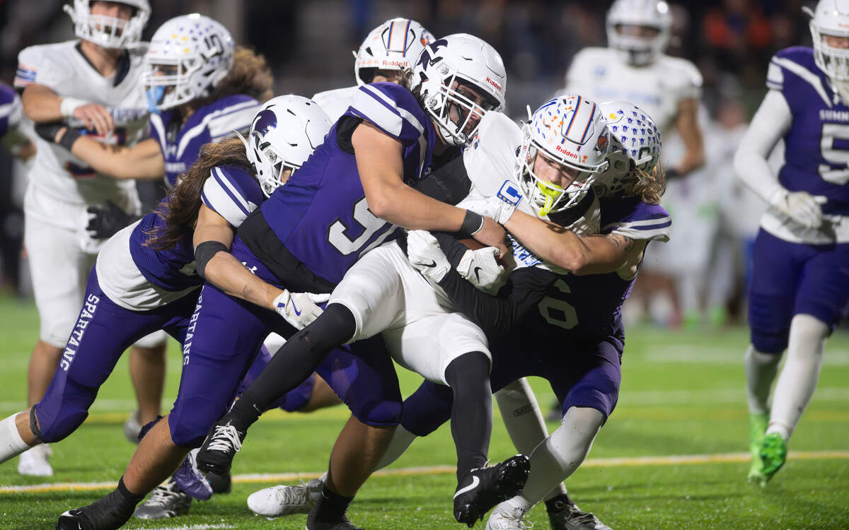 Graham Kapowsin wide receiver Kase Betz is wrapped up by Graham Kapowsin defenders (from left) Elias Isaacs, Shaun Griffith and Taylor Rebar during Friday night’s football game at Sunset Chev Stadium in Sumner, Washington, on Nov. 1, 2024. Sumner won the game, 23-11.