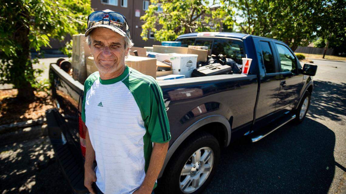 Matt Yablon stands next to some of his belongings while moving from the Tiki Apartments in Tacoma on July 3, 2018. Yablon’s and others’ eviction from the building prompted the City of Tacoma to begin debating new protections for renters.