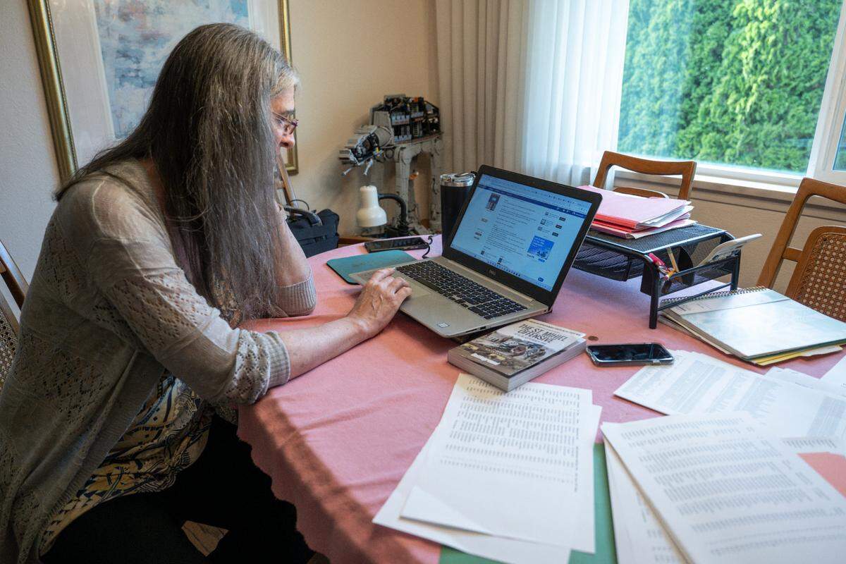 Lynn Goralski shares sites used to research for a trip to photograph graves from World War I on Wednesday, June 11, 2025, in Tacoma, Wash.