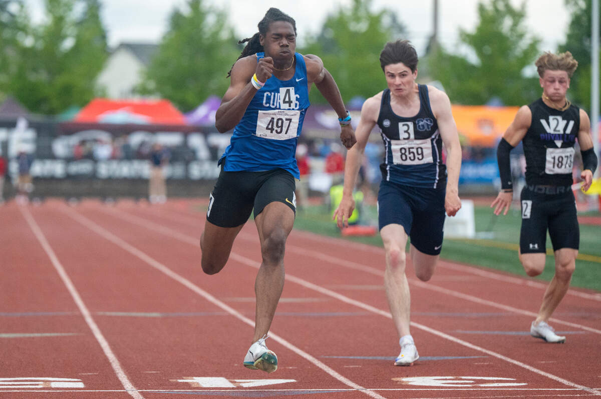 Curtis’ Nicholas Altheimer, left, sprints into the finish of the 4A 100-meter dash final on Saturday, May 31, 2025, during the 2025 WIAA Track & Field Championships at Mount Tahoma High School in Tacoma, Wash.