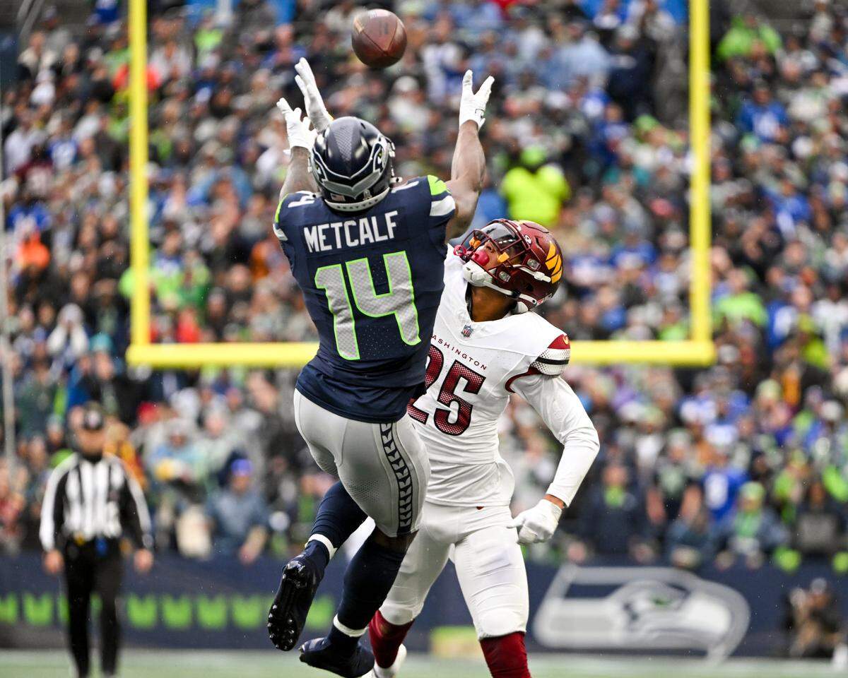 Seattle Seahawks wide receiver DK Metcalf (14) nearly catches a pass against Washington Commanders cornerback Benjamin St-Juste (25) during the first quarter of the game at Lumen Field, on Sunday, Nov. 12, 2023, in Seattle, Wash.