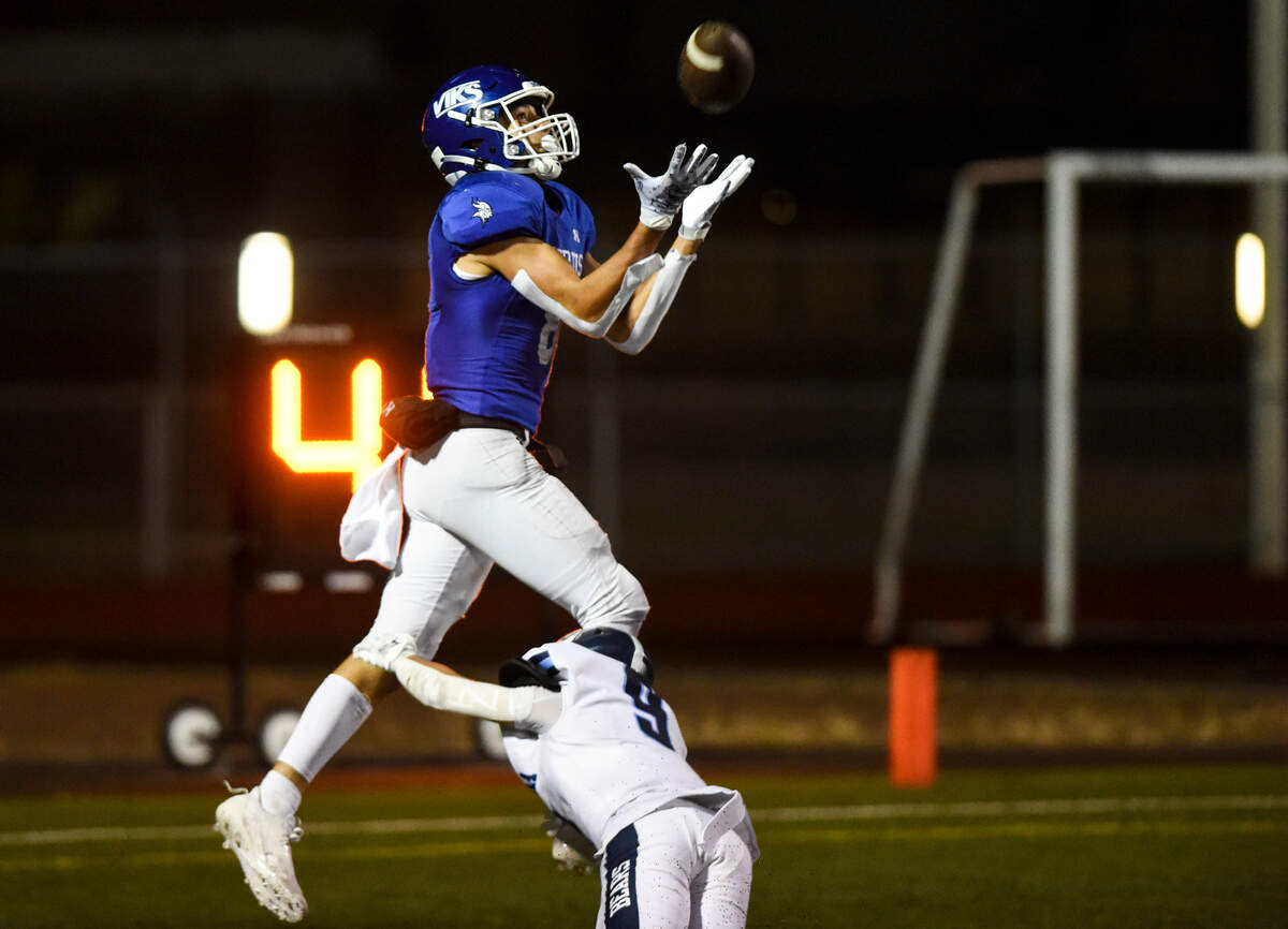 Curtis’s Xavier Ahrens (8) catches a touchdown pass against Olympia’s Joshua Muckian (9) during the second half of the high school football game at Curtis Senior High School, Thursday, Aug. 31, 2023, University Place, Wash.