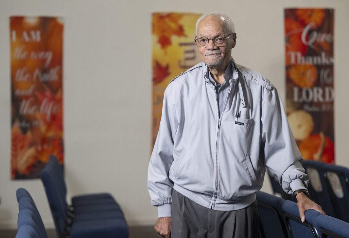 Pastor Roy Fletcher stands between rows of the sanctuary at Sheridan Street Community Church of God on Friday, Nov. 14, 2025, in Tacoma, Wash. Fletcher announced his retirement after six decades of service at the church.