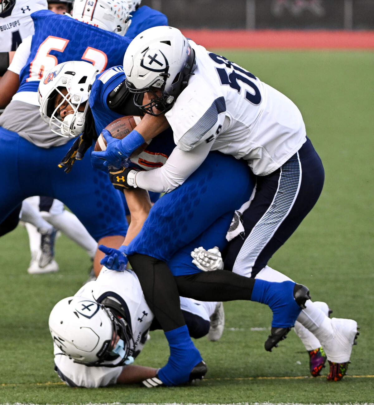 Graham-Kapowsin’s Jabez Woods (10) is tackled by Gonzaga Prep’s Camden Fletcher (56) and Luke Hills (35) during the first half of the 4A quarterfinal state championship game at Art Crate Field, Saturday, Nov. 18, 2023, in Spanaway, Wash.