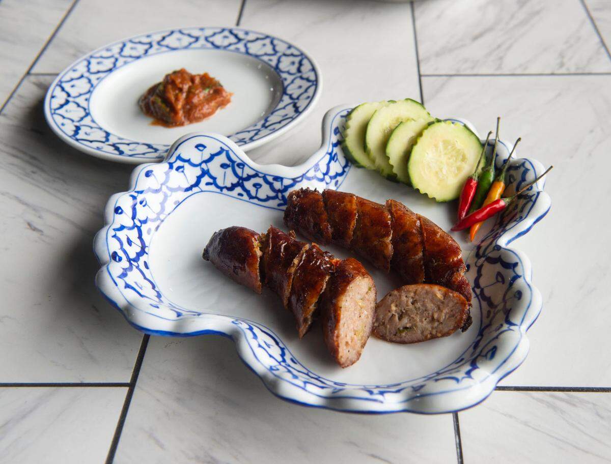 Sai oua, a pork Laotian sausage served with a roasted vegetable dip, is fragrant with lemongrass, makrut lime leaf and galangal.