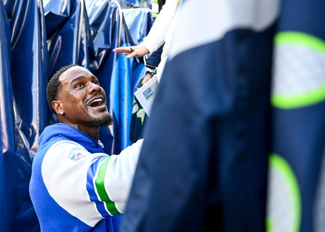 Seattle Seahawks defensive end Frank Clark (57) signs autographs before the game against the Cleveland Browns at Lumen Field, Sunday, Oct. 29, 2023, in Seattle, Wash.