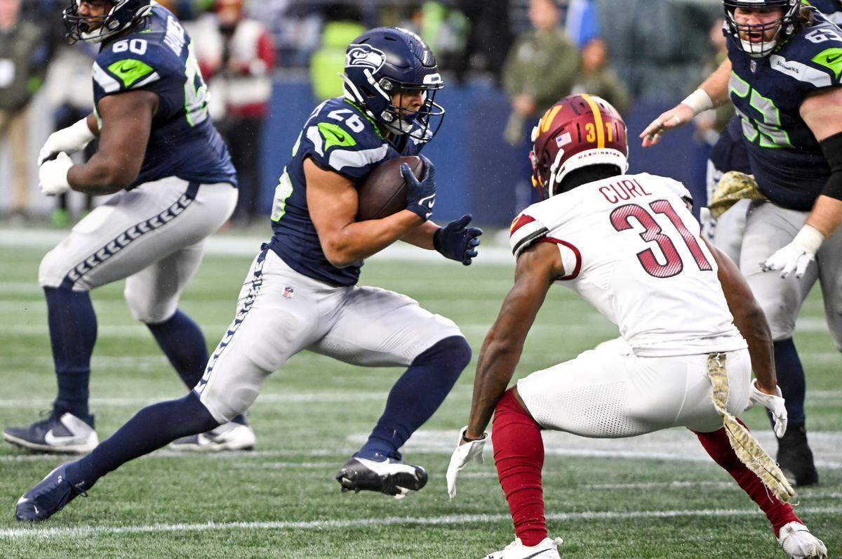 Seattle Seahawks running back Zach Charbonnet (26) carries the ball during the third quarter of the game against the Washington Commanders at Lumen Field, on Sunday, Nov. 12, 2023, in Seattle, Wash.
