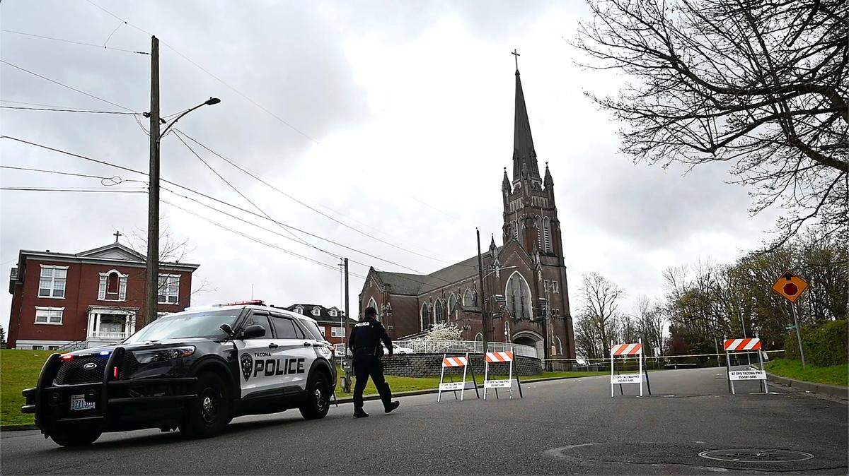 A Tacoma police officer and vehicle are pictured during an investigation in late March of 2024.