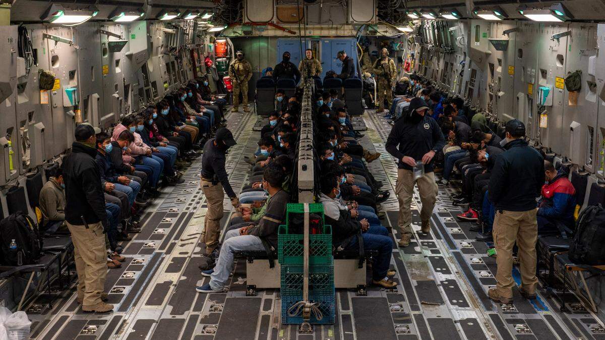Immigrants await takeoff for a removal flight at the Tucson International Airport, Ariz., Jan. 23, 2025. Under the direction of U.S. Northern Command, U.S. Transportation Command is supporting Immigration and Customs Enforcement removal flights by providing military airlift. (Dept. of Defense photo by Senior Airman Devlin Bishop)