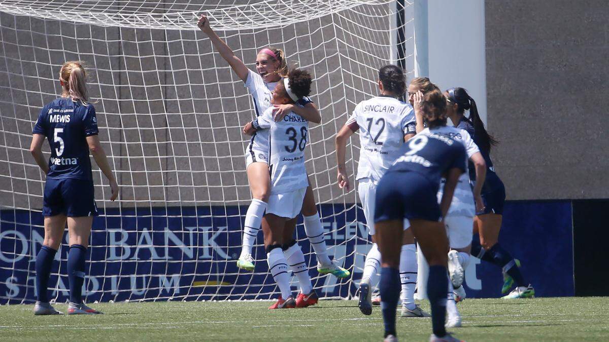 Portland Thorns’ Morgan Weaver, rear, celebrates with teammate Simone Charley (38) after scoring against the North Carolina Courage during the second half of an NWSL Challenge Cup soccer match at Zions Bank Stadium Friday, July 17, 2020, in Herriman, Utah. (AP Photo/Rick Bowmer)