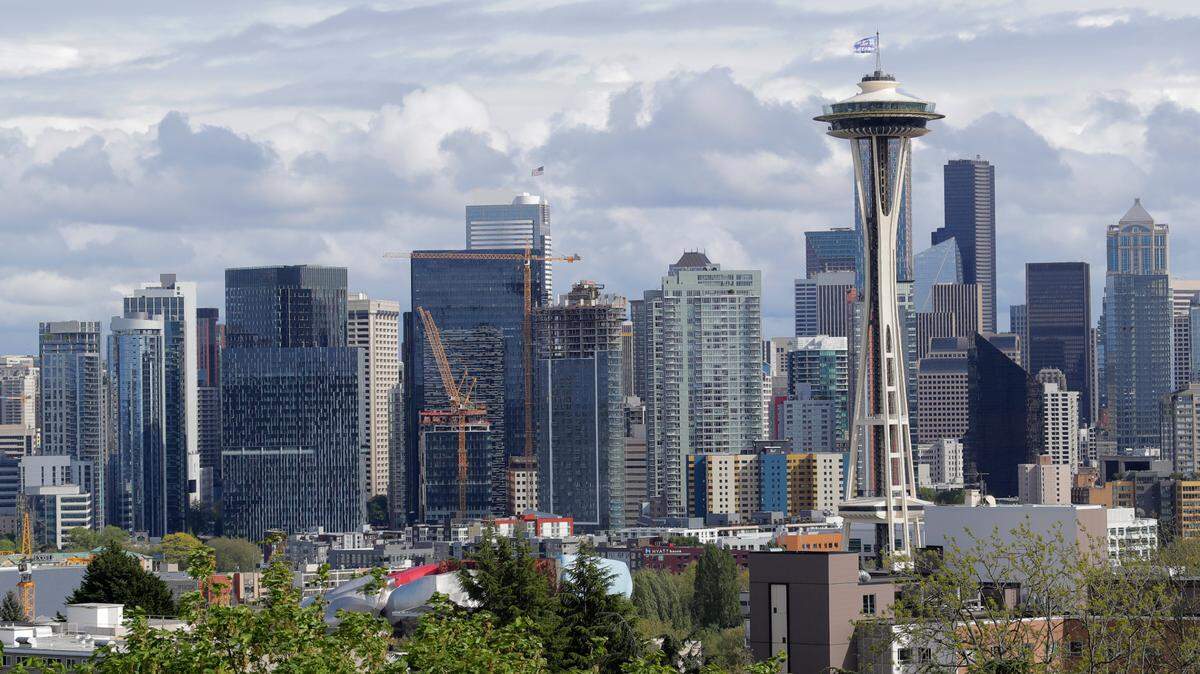 The Space Needle and the Seattle skyline are shown against a cloudy sky on April 30, 2020, as seen from Kerry Park. Three Seattle restaurants were named the best places in the U.S. to eat at in 2021, according to The New York Times.