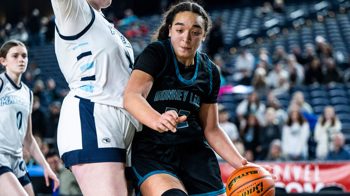 Bonney Lake center Jazmyn Shipp (22) drives to the basket as Meadowdale forward Audrey Lucas (35) guards her during an opening round game at the WIAA state basketball tournament in the Tacoma Dome in Tacoma, Washington, on Wednesday, March 1, 2023. Shipp scored her 1,000th career point during the game. Bonney Lake lost the game 35-62.
