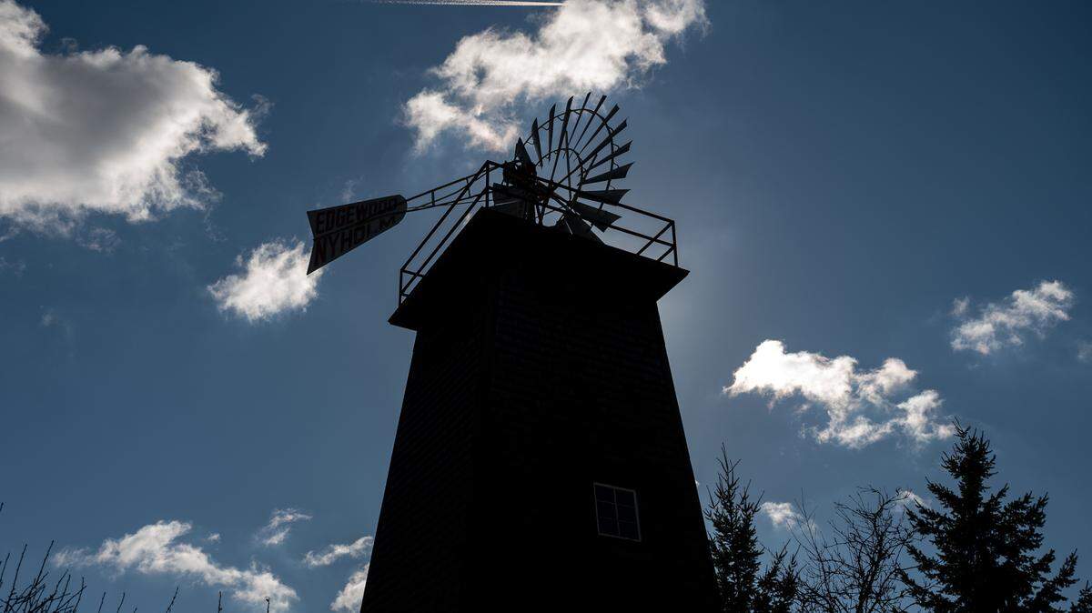 The old windmill at Nyholm’s Market is silhouetted by the Saturday afternoon sun in Edgewood, Wash.