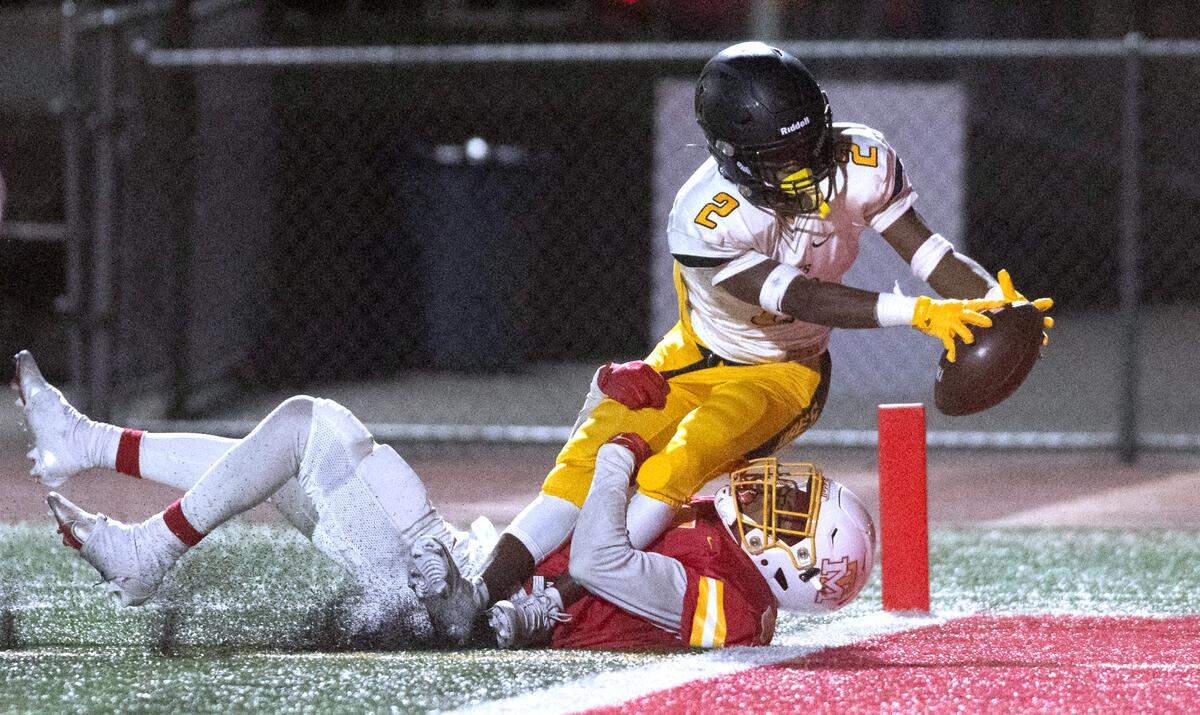 Lincoln wide receiver Maurice Gosby stretches into the end zone for a touchdown over Mount Tahoma defensive back Deonjae Ervin during Friday night’s football game at Mount Tahoma High School in Tacoma, Washington, on Sept. 20, 2023. Mount Tahoma won the game, 24-20.