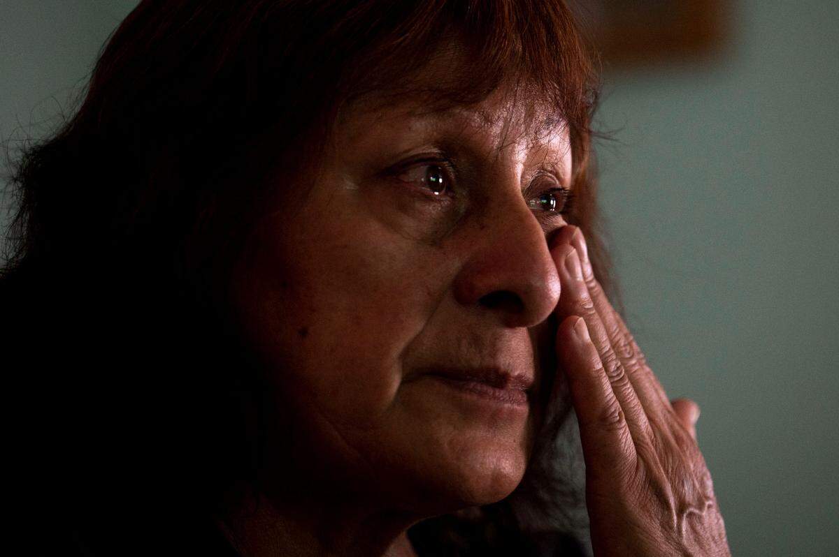 Maria Gonzalez wipes tears from her eyes after talking about the possibility of her family being split up after moving away from Meridian Estates mobile home park in Puyallup, Wash., on Tuesday, July 26, 2022. Gonzalez’s son, Brian Aragon, was severely injured in a car accident a few years ago. Maria and her husband, Armando Aragon, have spent thousands of dollars on their home to make it ADA accessible for Brian.