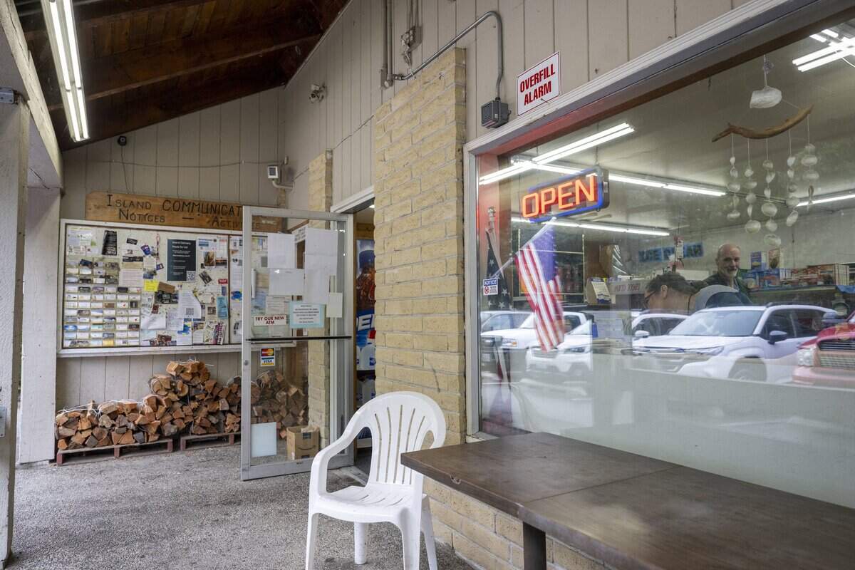 The door to Anderson Island General Store stands open as customers move about inside on the store's last day of business on Monday, Feb. 2, 2026, in Anderson Island, Wash.