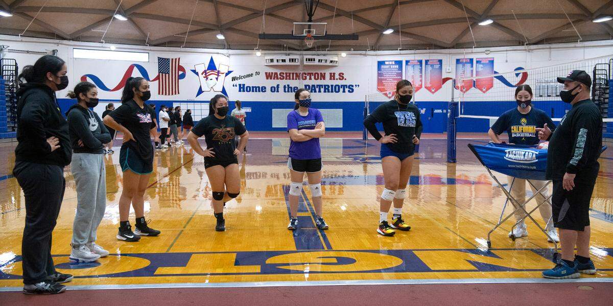 Washington High volleyball head coach Paul Souza (far right) directs the Patriots during volleyball practice at Washington High School in Tacoma, Washington, on Tuesday, March 2, 2021.