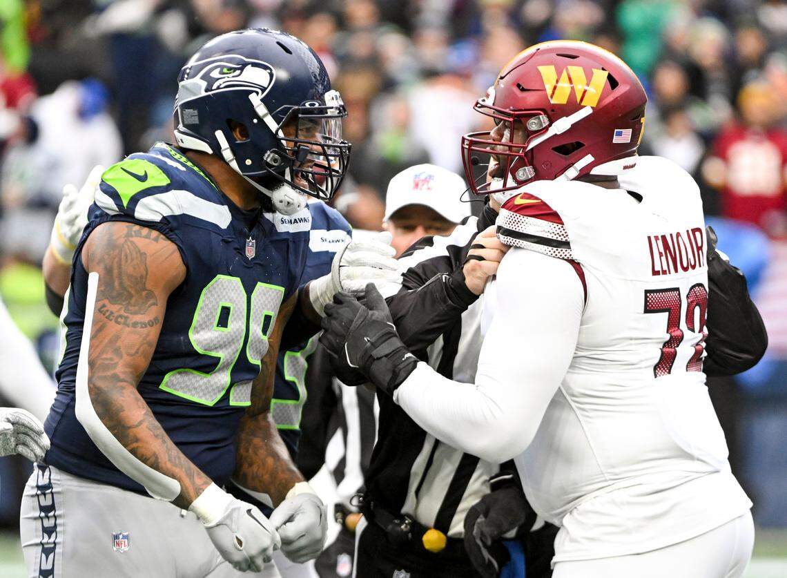 Seattle Seahawks defensive end Leonard Williams (99) and Washington Commanders offensive tackle Charles Leno Jr. (72) chirp at one another before refused could break it up during the second quarter of the game at Lumen Field, on Sunday, Nov. 12, 2023, in Seattle, Wash.