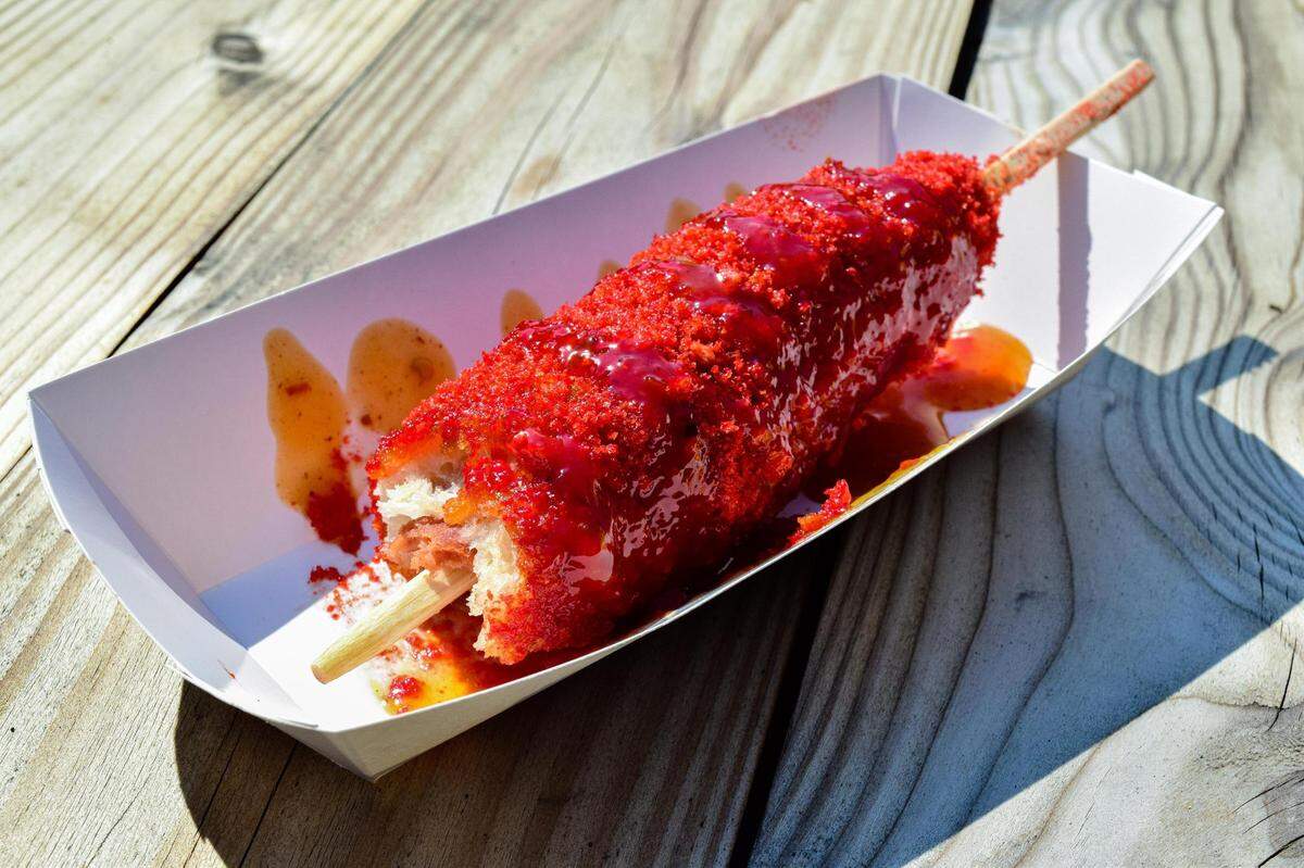 Mochinut also serves Korean corn dogs, here covered in Flaming Hot Cheetos and a spicy mango honey sauce.