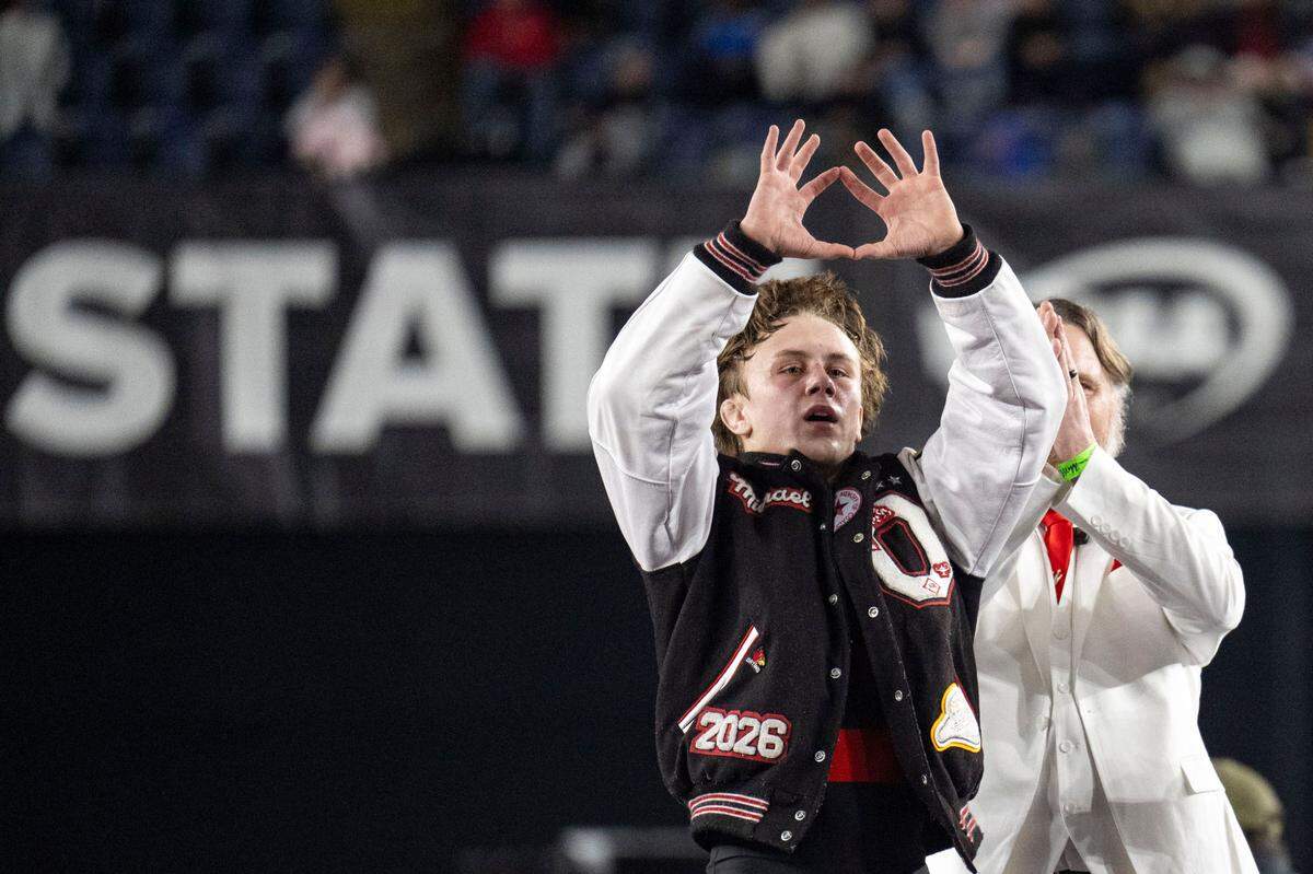 Orting’s Michael Fritz celebrates with head coach Jody Coleman after he defeated Burlington-Edison’s Chase Weber to win the Class 2A, 144-pound state title on Saturday, Feb. 22, 2025, at Mat Classic XXXVI at the Tacoma Dome in Tacoma, Wash.