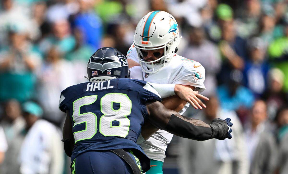 Seattle Seahawks linebacker Derick Hall (58) hits Miami Dolphins quarterback Skylar Thompson (19) after the throws during the first quarter of the game at Lumen Field, on Sunday, Sept. 22, 2024, in Seattle, Wash.
