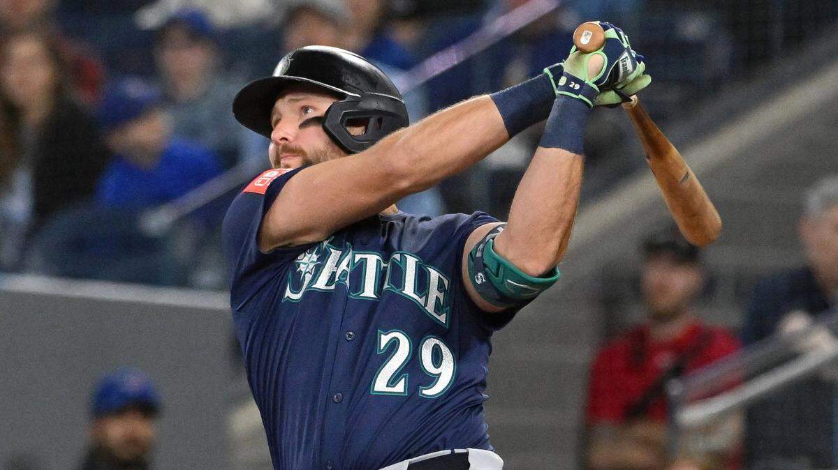 Apr 20, 2025; Toronto, Ontario, CAN;  Seattle Mariners catcher designated hitter Cal Raleigh (29) hits a two run home run against the Toronto Blue Jays in the first inning at Rogers Centre. Mandatory Credit: Dan Hamilton-Imagn Images