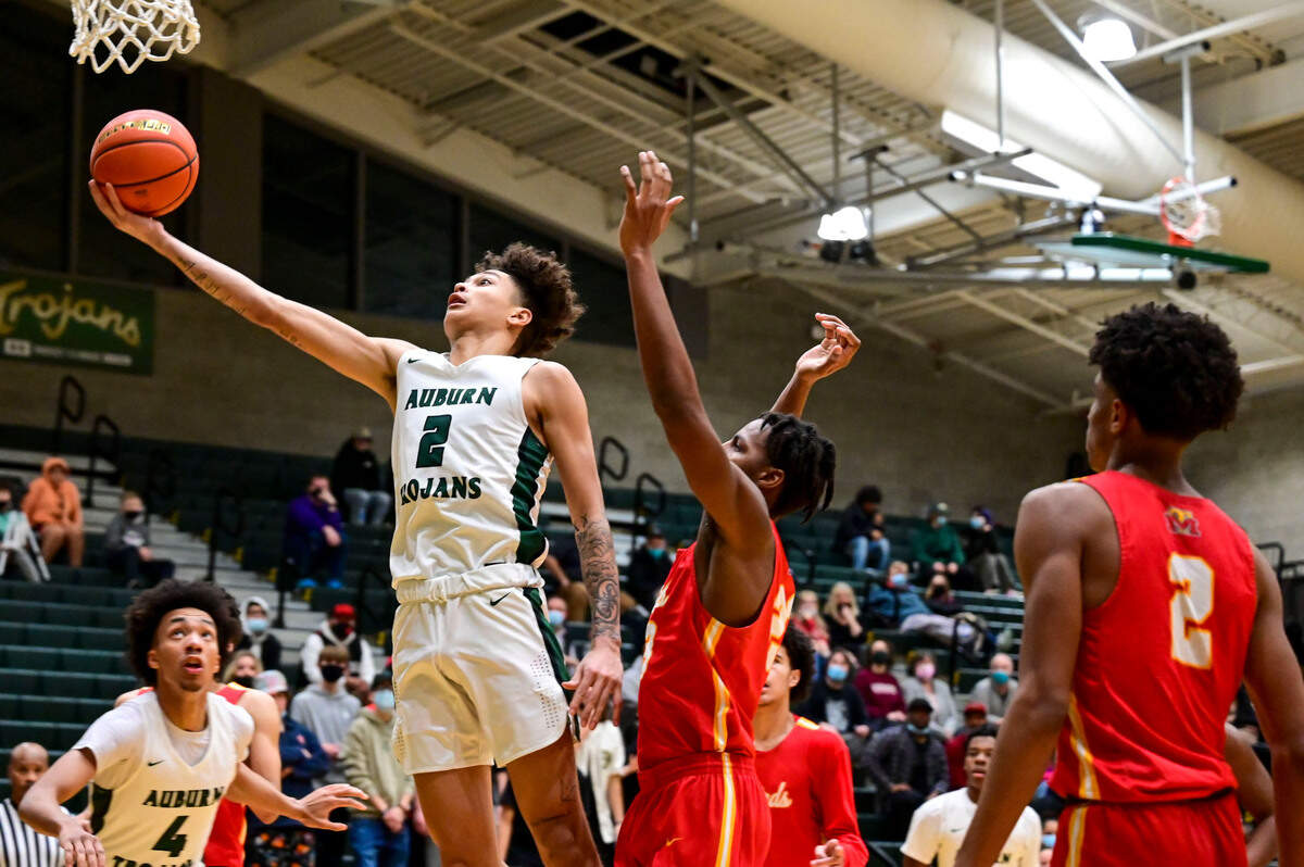 Auburn guard Trevon Blassingame (2) drives to the basket for a layup as Mount Tahoma forward DJ Laffitte (23) defends during the third quarter of a non-league game on Thursday, Jan. 20, 2022, at Auburn High School.