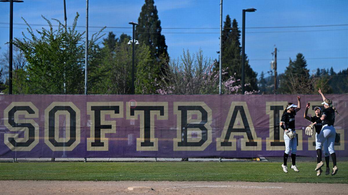Emerald Ridge outfield jumps in the air at the start of the inning during the softball game at Puyallup High School, on Friday, April 18, 2025, in Puyallup, Wash.