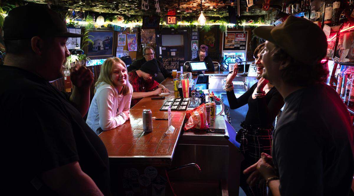 Mars Ferling (left center) talks with bartender Shiloh Robison and cook Beck Brewer at the historic Bob’s Java Jive tavern in Tacoma, Washington, on Monday, July 1, 2024.