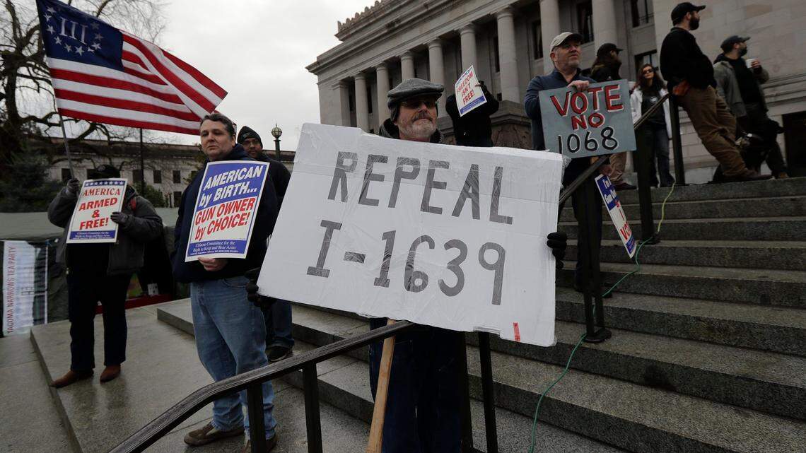 Rick Howell of Wenatchee (center) joins in a gun-rights rally on Jan. 18 at the state Capitol. Several county sheriffs have recently taken their own stands against Initiative 1639, which was passed by voters in November.