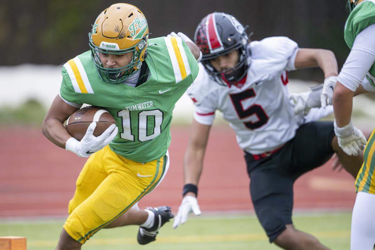 Tumwater running back Tyler Briscoe (10) is pushed out of bounds by on Saturday, Nov. 22, 2025, in Tumwater.