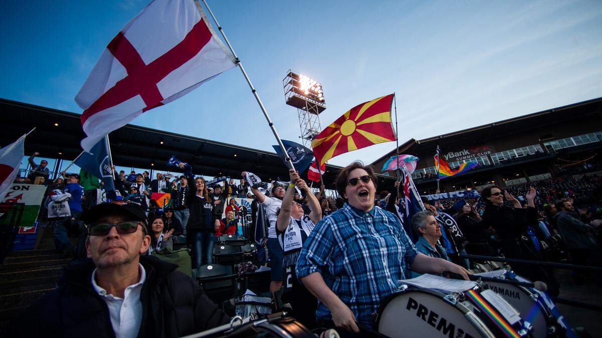 Fans celebrate after a goal by Reign FC’s Bethany Balcer in the first half. Reign FC played the Orlando Pride in a NWSL match at Cheney Stadium in Tacoma, Wash., on Sunday, April 21, 2019.