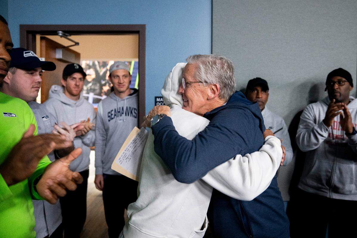 Former Seattle Seahawks head coach Pete Carroll, facing, hugs wide receiver Tyler Lockett as he leaves a media availability after it was announced he will not return as head coach next season, Wednesday, Jan. 10, 2024, at the NFL football team’s headquarters in Renton, Wash. Carroll will remain with the organization as an advisor. (AP Photo/Lindsey Wasson)