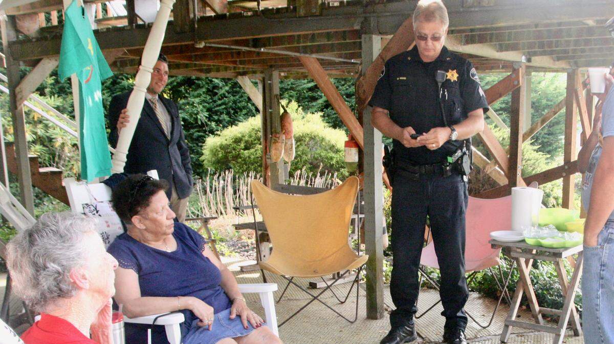 From left, charter Citizens Against Crime member Anne White, CAC vice president Dolores Starr, Jonathan Parisi, and Pierce County sheriff’s Sgt. Brian Ward celebrate the organization’s 30th anniversary.