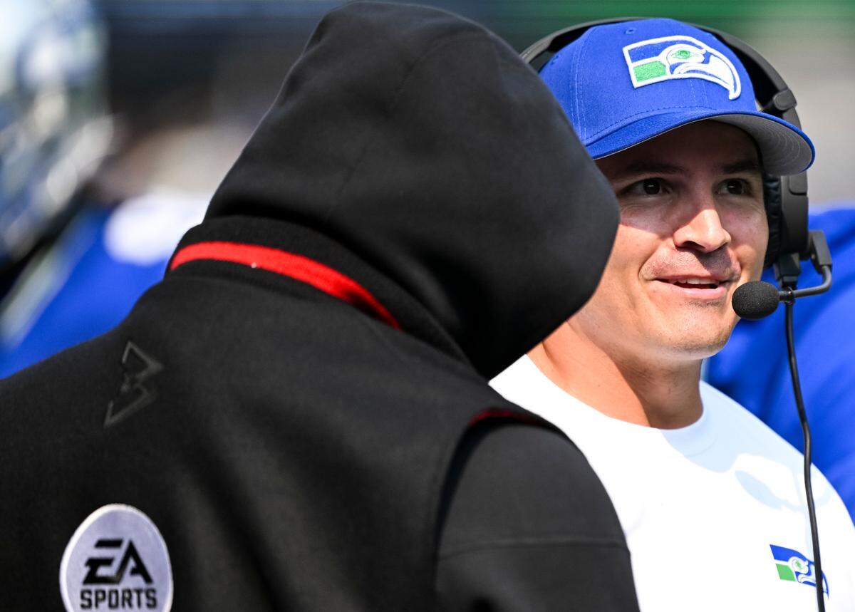 Seattle Seahawks head coach Mike Macdonald talks with former Seahawk running back Marshawn Lynch during the first quarter of the game against the Denver Broncos at Lumen Field, on Sunday, Sept. 8, 2024, in Seattle, Wash.