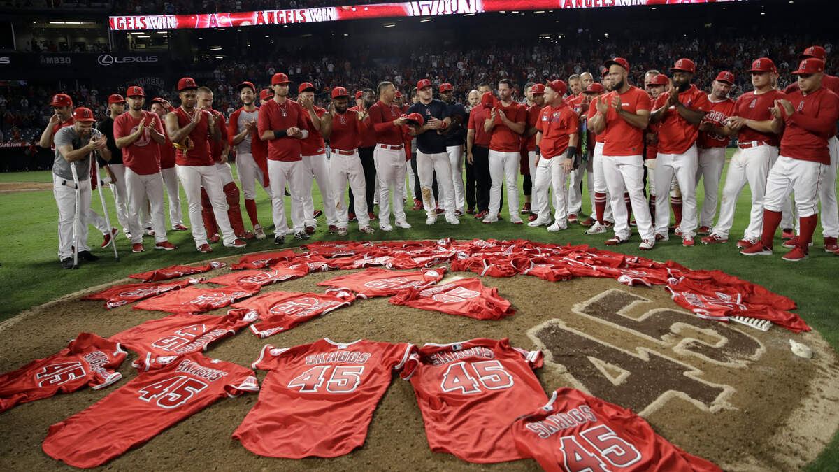 Members of the Los Angeles Angels place their jerseys with No. 45 in honor of pitcher Tyler Skaggs on the mound after a combined no-hitter against the Seattle Mariners during a baseball game Friday, July 12, 2019, in Anaheim, Calif. The Angels won 13-0.