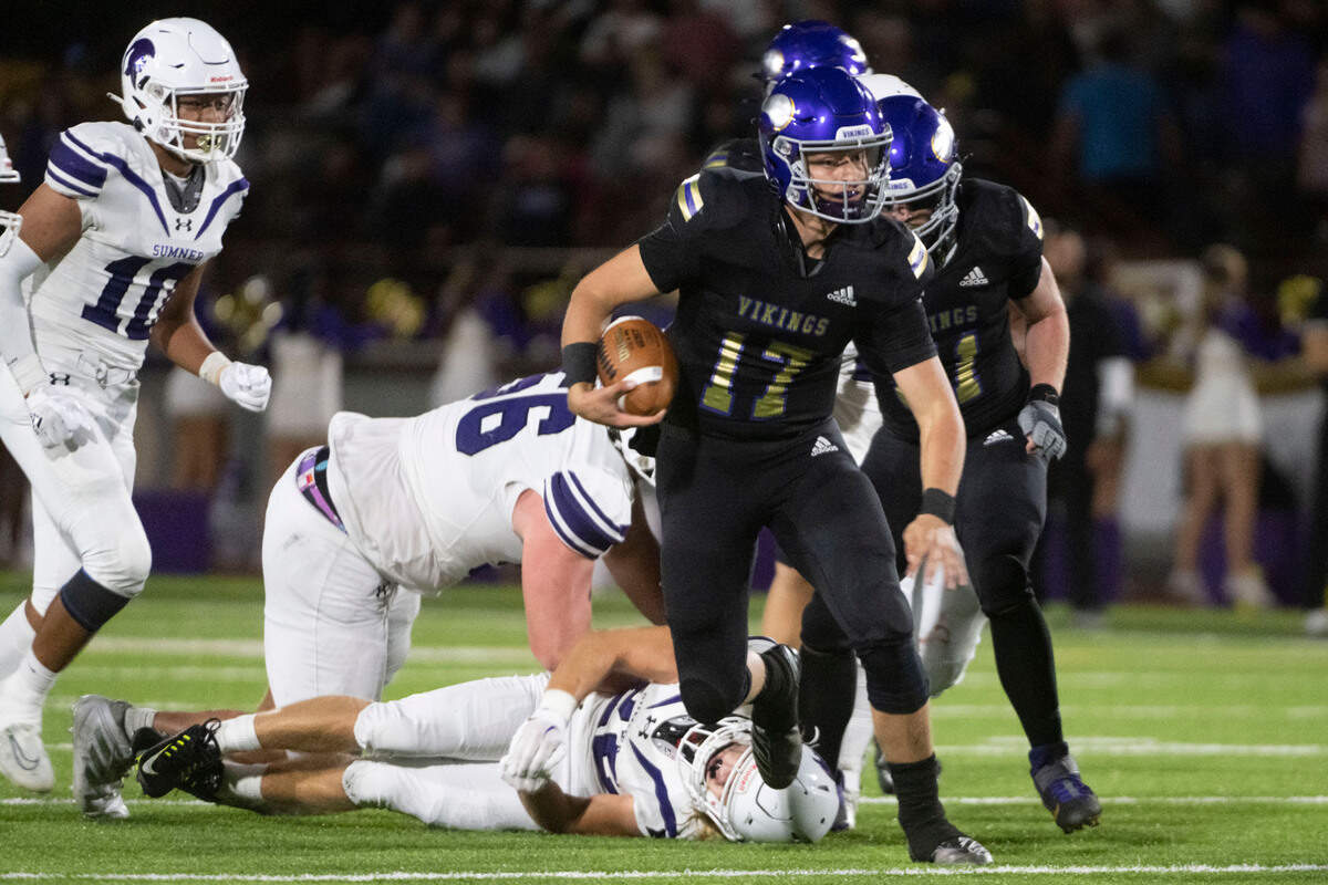 Puyallup quarterback Kaden Rolfsness scrambles for a gain through the Sumner defense during the second quarter of a 4A SPSL game on Friday, Sept. 23, 2022, at Sparks Stadium in Puyallup, Wash.
