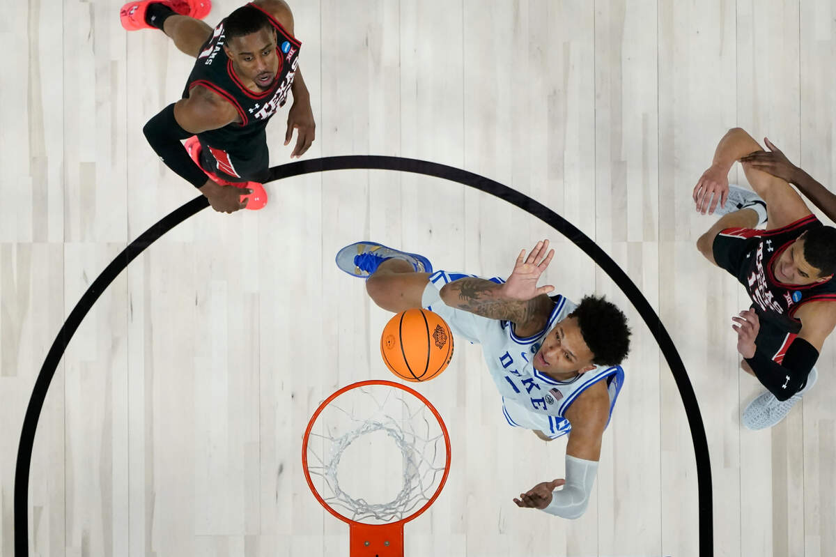 Duke forward Paolo Banchero, bottom, shoots against Texas Tech during the second half of a college basketball game in the Sweet 16 round of the NCAA tournament in San Francisco, Thursday, March 24, 2022. (AP Photo/Marcio Jose Sanchez)