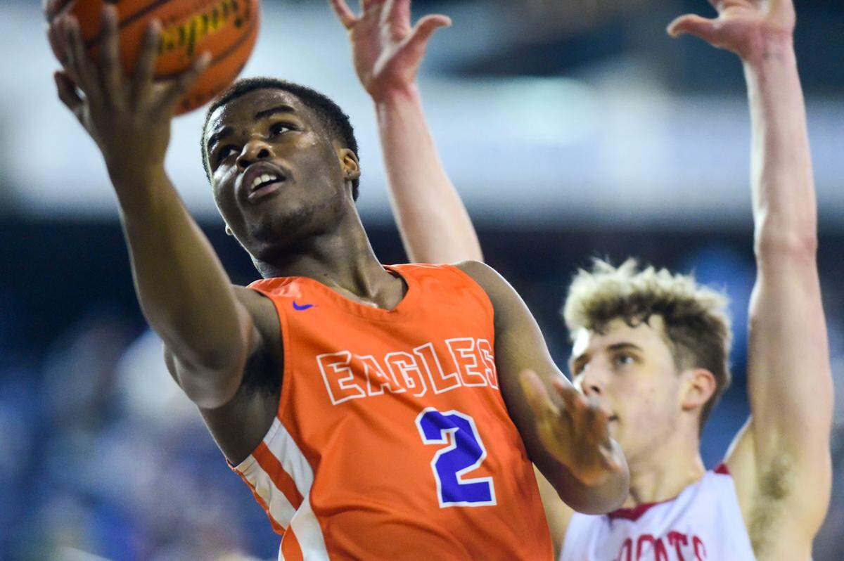 Graham-Kapowsin’s Elijah Cain (2) attempts a layup as Mount Si forward Quin Patterson (15) defends during the third quarter of a Class 4A quarterfinal state tournament game on Thursday, March 3, 2022, at the Tacoma Dome, in Tacoma, Wash.