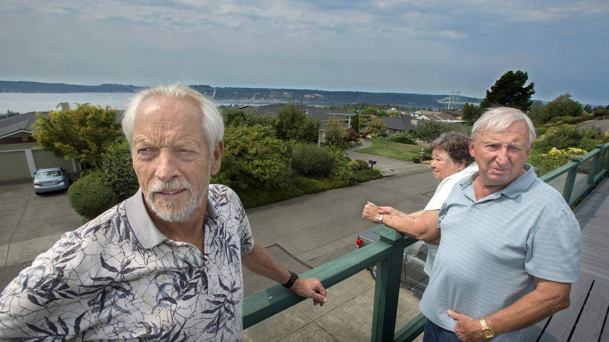 West Slope Neighborhood Coalition co-chair Dean Wilson, left, says the group is organizing homeowners in the Narrowmoor subdivision to jointly submit documents to modify racist language in their property records dating to the 1940s. Doing so is now possible under a new state law. Wilson is shown here looking out at the neighborhood with fellow homeowners Nancy and Mike Fleming.