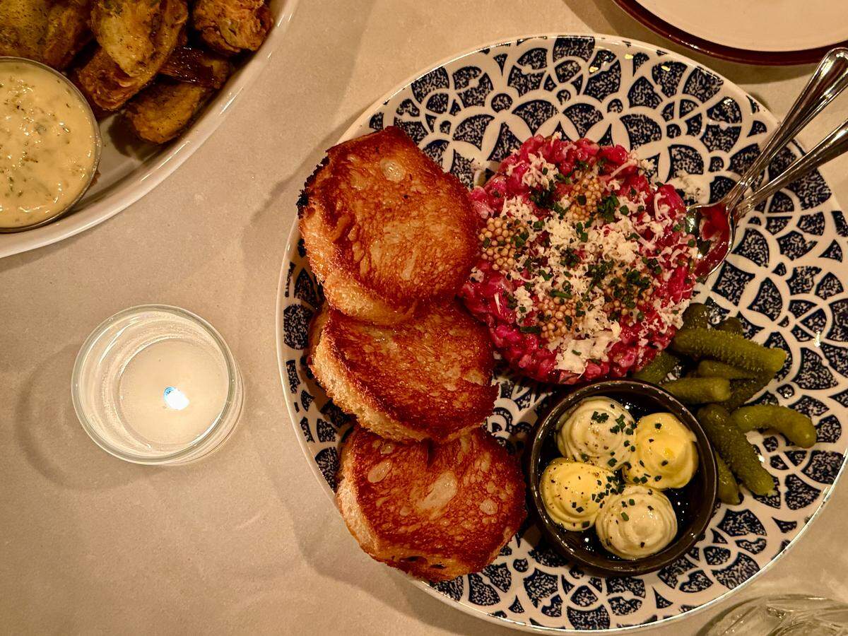 Among a few updates at the new Wooden City is a lovely beef tartare with grilled toasts, mayo and cornichons, and fried artichokes (upper left).