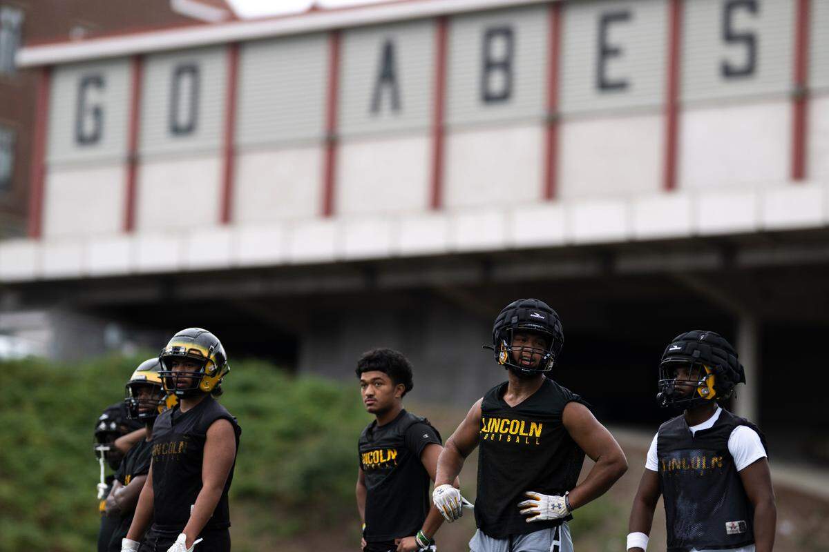 Lincoln’s defense listens to play calls during a football practice at Lincoln high School, on Wednesday, Aug. 21, 2024, in Tacoma, Wash.