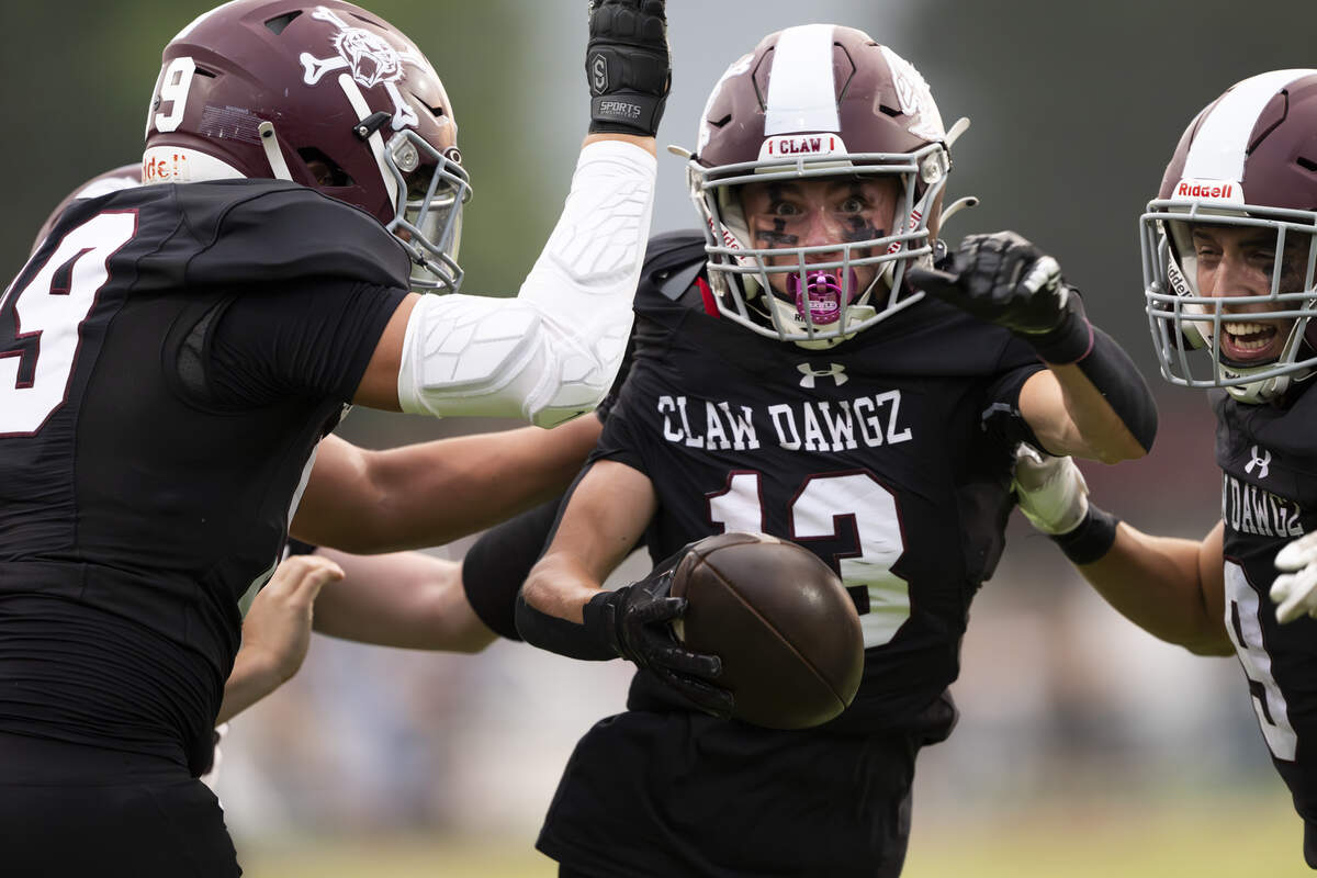 Enumclaw Hornets defensive back Cameron Donovan (13) reacts to recovering the fumble from Decatur Golden Gators tight end Omaha Lutu-Ili (26) during the first half of the game at Pete’s Pool, on Thursday, Sept. 4, 2025, in Enumclaw, Wash.