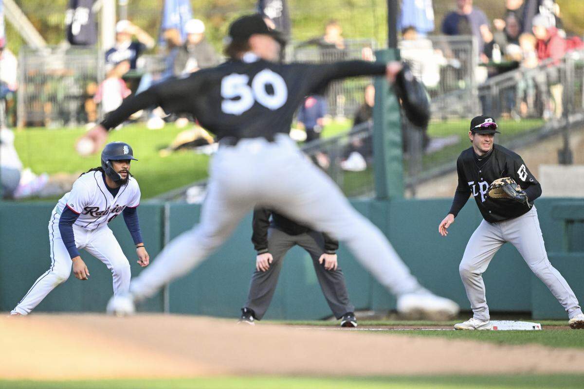 Mariners shortstop J.P. Crawford (0), on a rehab assignment with the Tacoma Rainiers, steps off first base during a pitch by El Paso Chihuahuas pitcher Jp Sears (50) on Tuesday, March 31, 2026, at Cheney Stadium in Tacoma, Wash.