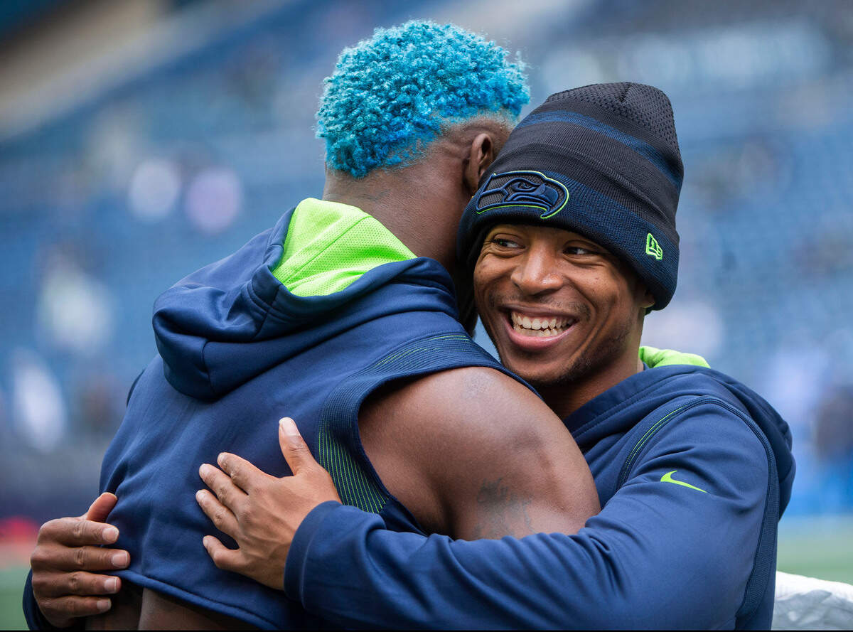 Seahawks receivers Tyler Lockett, right, and DK Metcalf share some love prior to the Seattle Seahawks playing the Tennessee Titans in an NFL football game at Lumen Field in Seattle, Wash., on Sunday, Sept. 19, 2021.