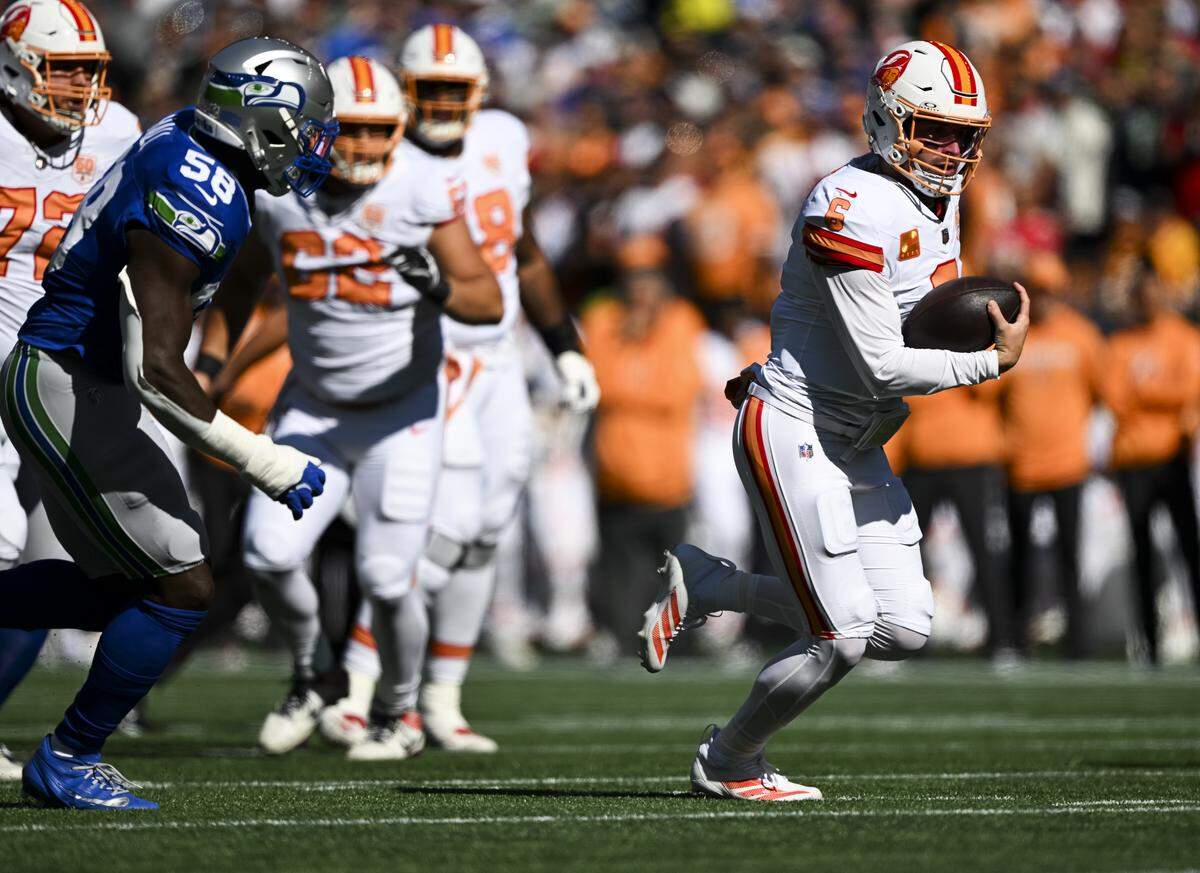 Tampa Bay Buccaneers quarterback Baker Mayfield (6) scrambles during the first quarter of the game against the Seattle Seahawks at Lumen Field, on Sunday, Oct. 5, 2025, in Seattle.