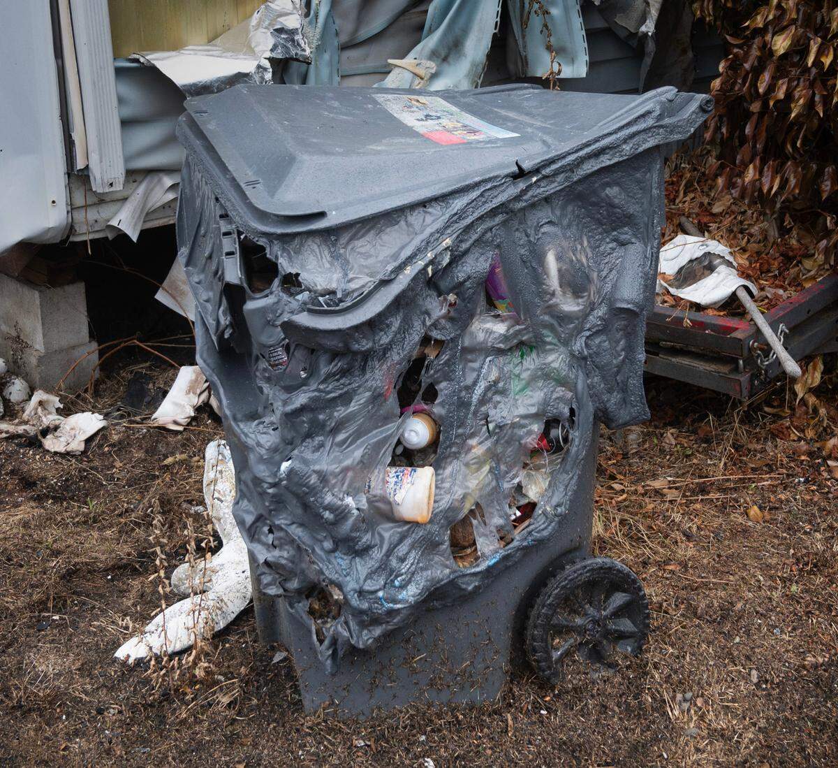 Michael Fletcher’s garbage can destroyed by radiant heat from last week’s wildfire at the Jamestown Estates mobile home park in Lakewood, Washington, shown on Wednesday, Aug. 9, 2023.