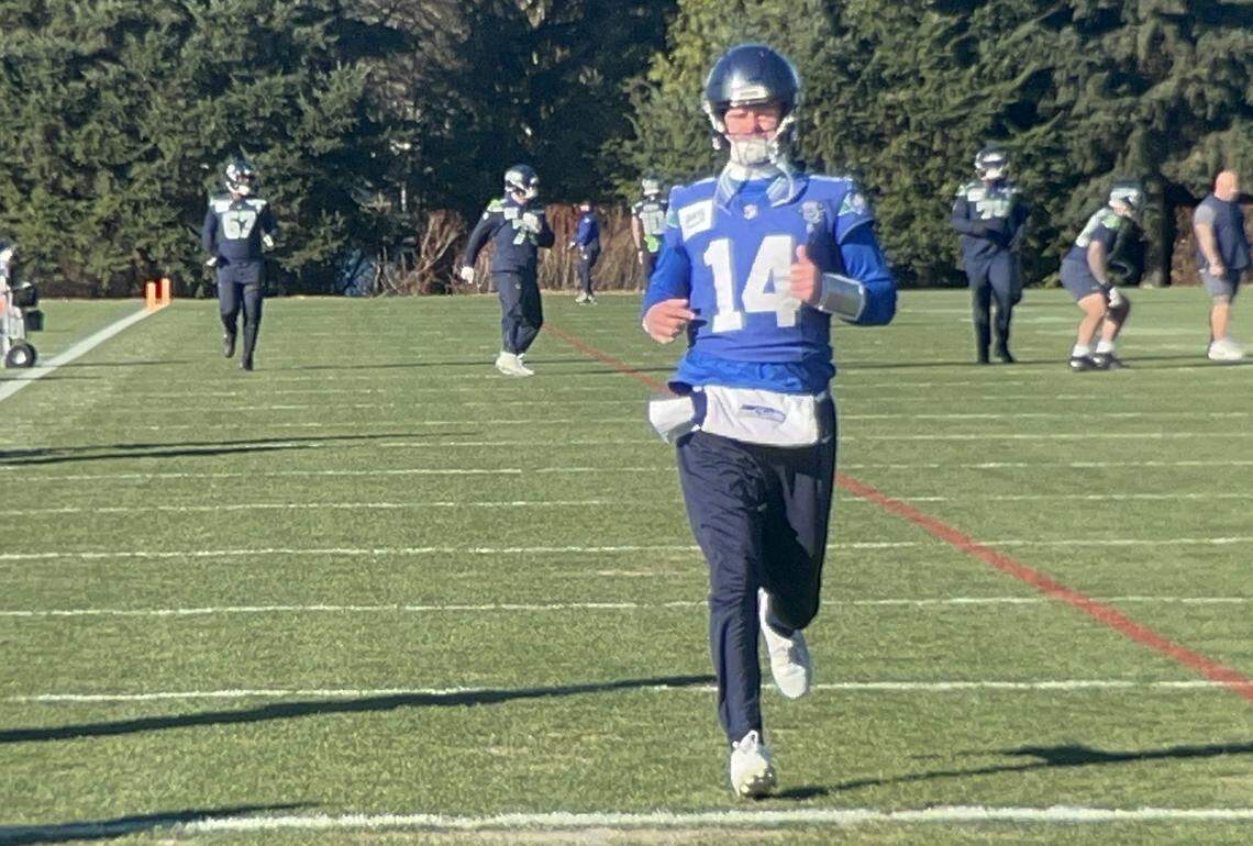 Sam Darnold (14, foreground) and Charles Cross (67, background) practicing Friday, Jan. 23, 2026, at the Virginia Mason Athletic Center two days before the Seahawks host the Los Angeles Rams in the NFC championship game at Lumen Field in Seattle.