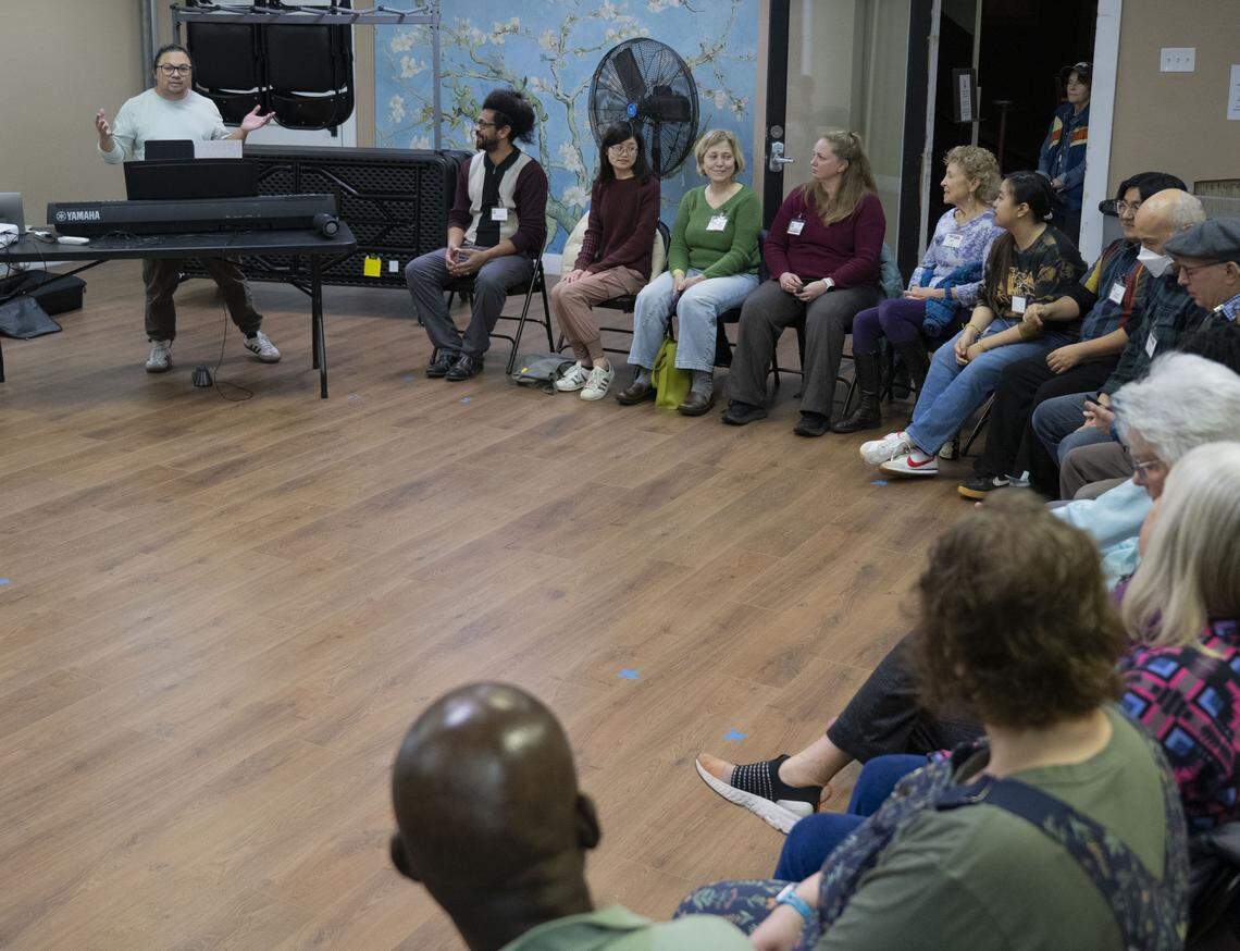Orlando Morales, artistic director, leads the Tacoma Refugee Choir during a practices for their upcoming concert, on Tuesday, Jan. 13, 2026 in Tacoma.