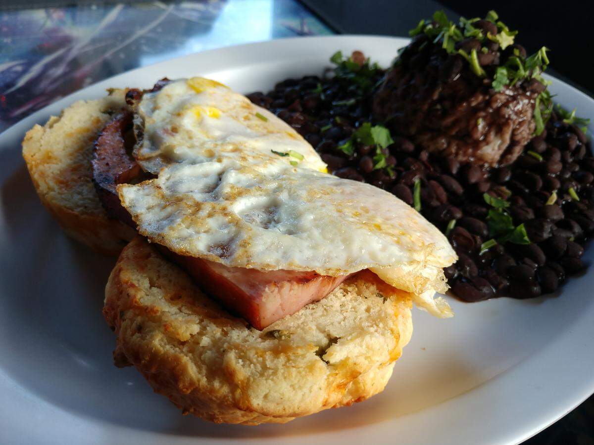 The Cure is served with ham steak, eggs, biscuits and beans and rice at The Church Cantina.